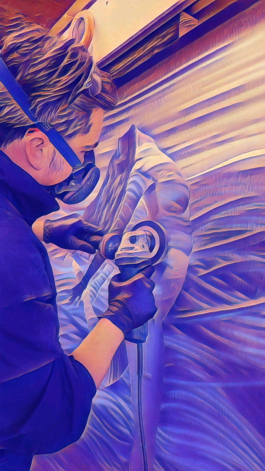Joseph Bernd grinding and burnishing a metal panel in his studio